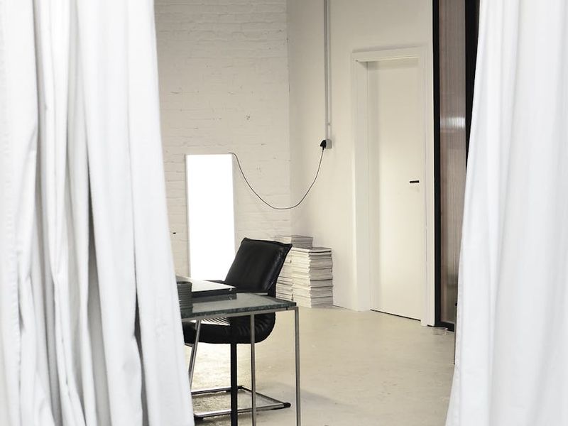 A serene and spacious room for yoga practice with minimalist decor.